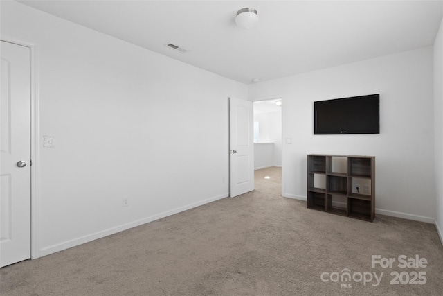 unfurnished bedroom featuring light carpet, visible vents, and baseboards