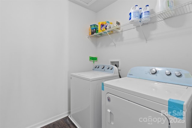 laundry area with laundry area, baseboards, dark wood-style flooring, and washing machine and clothes dryer