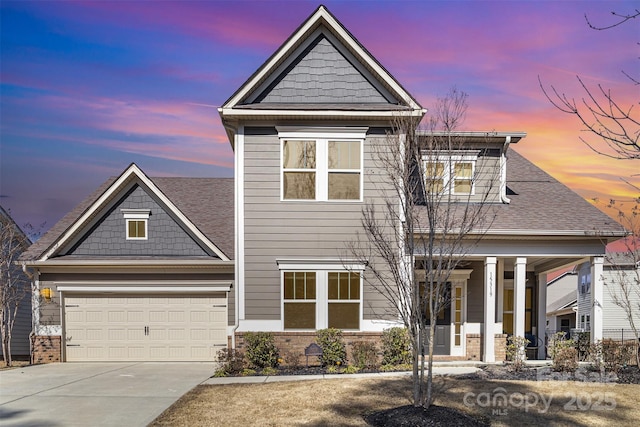 craftsman-style house with a porch, roof with shingles, driveway, and an attached garage