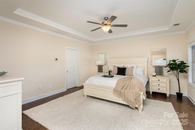 bedroom featuring ceiling fan, visible vents, baseboards, dark wood finished floors, and crown molding