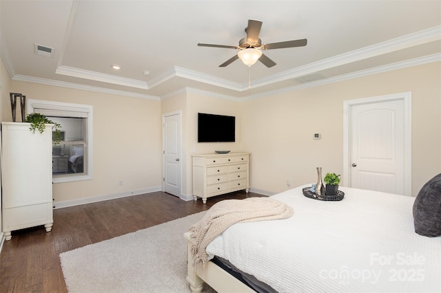 bedroom with crown molding, visible vents, a ceiling fan, wood finished floors, and baseboards