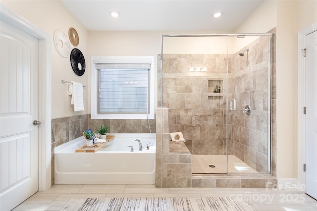 full bath featuring a stall shower, recessed lighting, and a bath