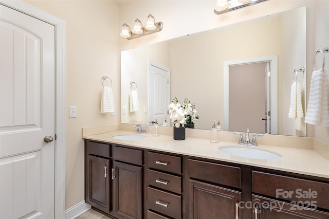 full bathroom with a sink and double vanity