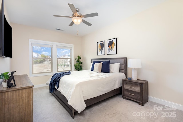 bedroom featuring light carpet, baseboards, visible vents, and ceiling fan