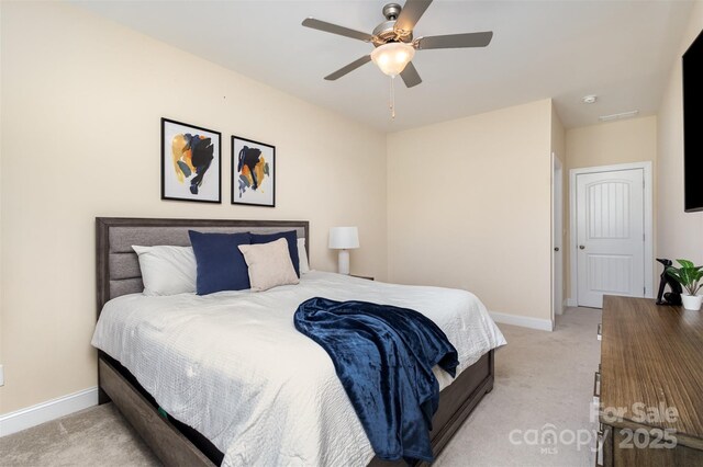 bedroom featuring light carpet, ceiling fan, and baseboards