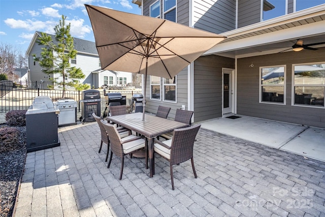 view of patio / terrace featuring ceiling fan, outdoor dining space, fence, and a grill