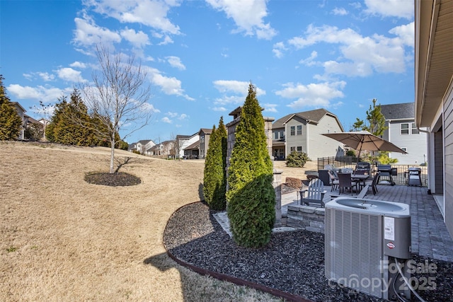 view of yard featuring cooling unit, a patio area, and a residential view