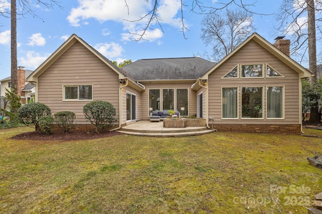 rear view of property featuring a yard and a patio area