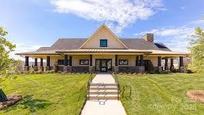 farmhouse featuring a front yard and a chimney