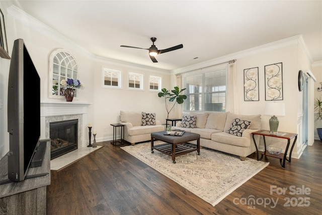 living room featuring dark wood-style floors, ornamental molding, and a high end fireplace