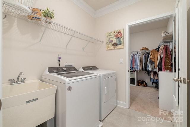 laundry area with light carpet, laundry area, independent washer and dryer, crown molding, and a sink