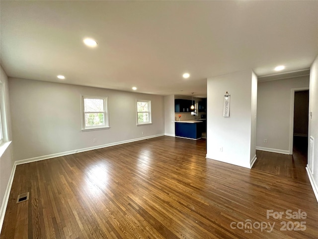 unfurnished living room with dark hardwood / wood-style floors