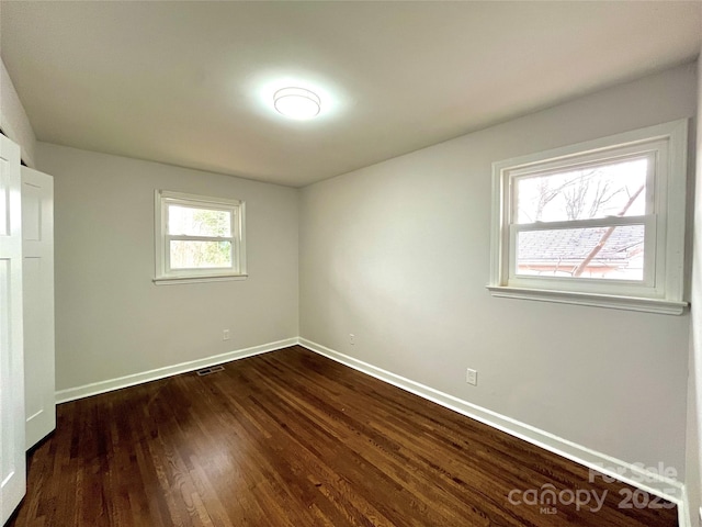 unfurnished bedroom featuring dark hardwood / wood-style flooring