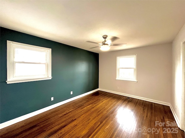 unfurnished room featuring ceiling fan and dark hardwood / wood-style flooring