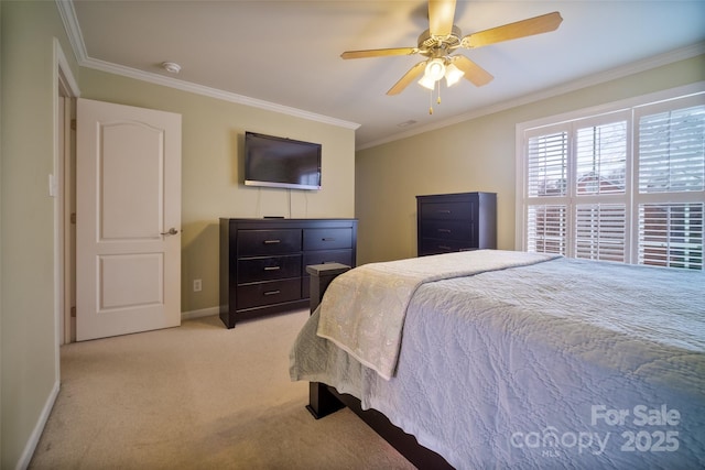 carpeted bedroom featuring crown molding and ceiling fan