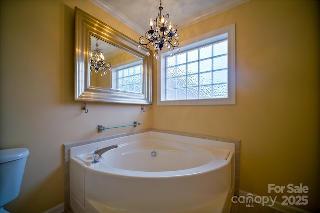 bathroom featuring a notable chandelier, ornamental molding, toilet, and a bathing tub