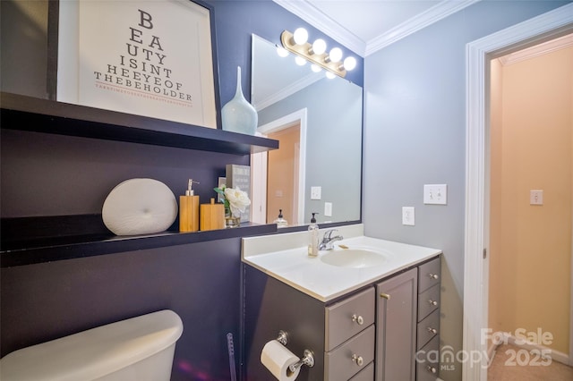 bathroom with ornamental molding, toilet, and vanity