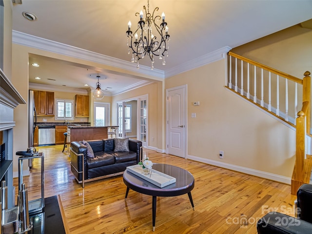 living room featuring ornamental molding and light hardwood / wood-style flooring