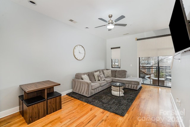 living room featuring ceiling fan and wood-type flooring