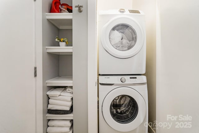 laundry area featuring stacked washer and clothes dryer