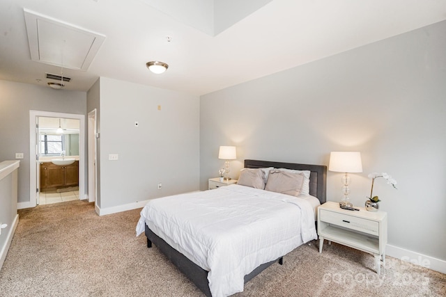 bedroom with sink, carpet floors, and ensuite bathroom