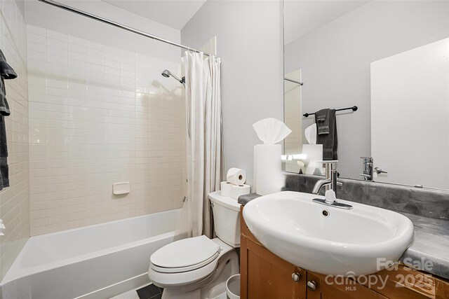 full bathroom with shower / bathtub combination with curtain, vanity, and toilet