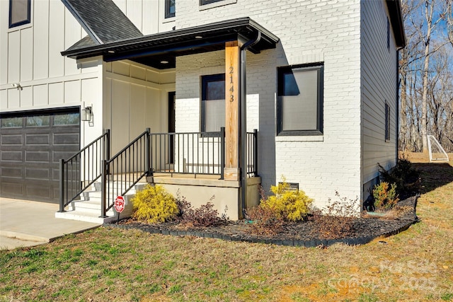 view of exterior entry featuring a garage and covered porch