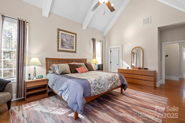 bedroom featuring hardwood / wood-style flooring, high vaulted ceiling, beam ceiling, and ceiling fan