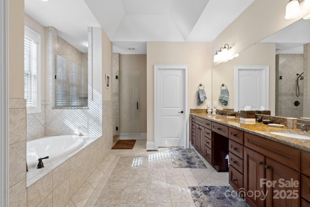 bathroom featuring shower with separate bathtub and vanity