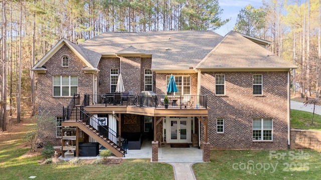 view of front facade with a patio, a front lawn, a deck, and french doors