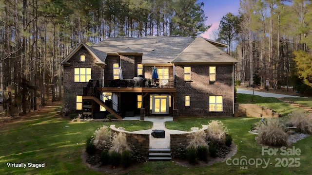 view of front of house with a patio, a lawn, and a wooden deck