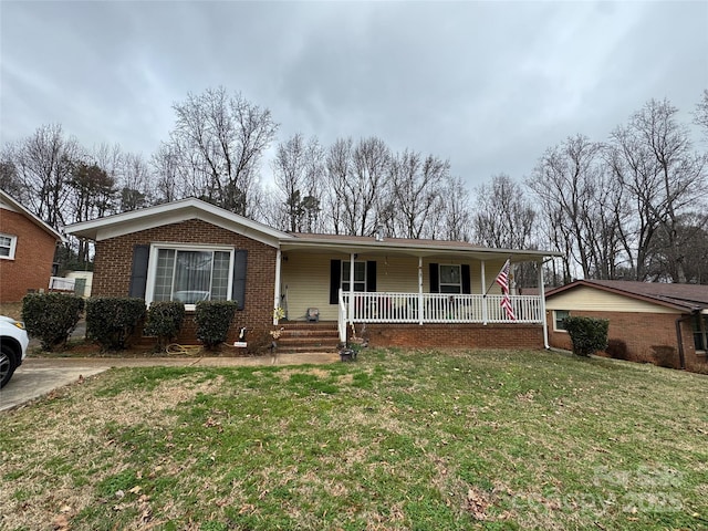 ranch-style house with a front yard and covered porch