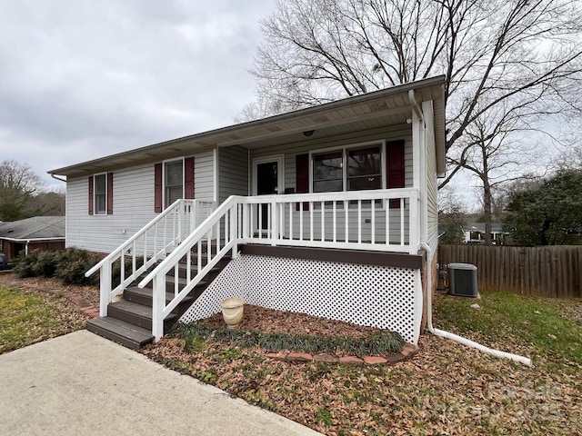 view of front facade featuring covered porch and central air condition unit