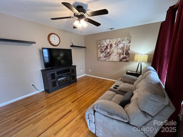 living room with hardwood / wood-style flooring and ceiling fan