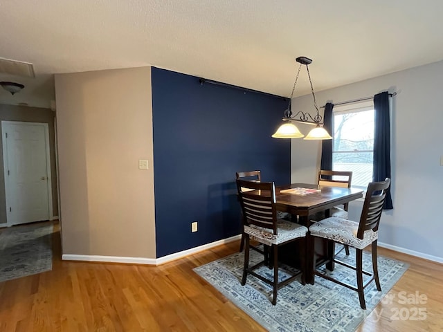 dining area with hardwood / wood-style flooring