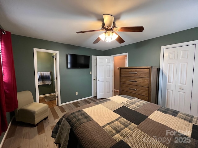 bedroom with a closet, ensuite bath, dark hardwood / wood-style floors, and ceiling fan