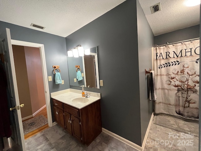 bathroom with vanity and a textured ceiling