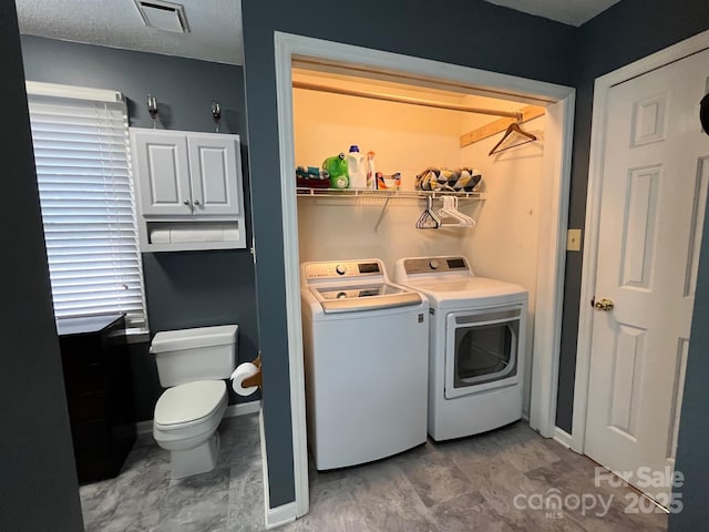 washroom with washing machine and clothes dryer