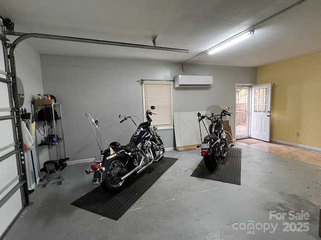 workout area featuring an AC wall unit and a textured ceiling