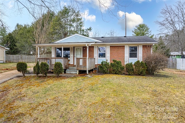 view of front of home featuring covered porch and a front yard