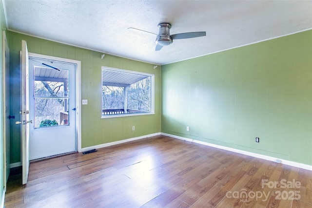 interior space with light wood-type flooring, ceiling fan, and a textured ceiling