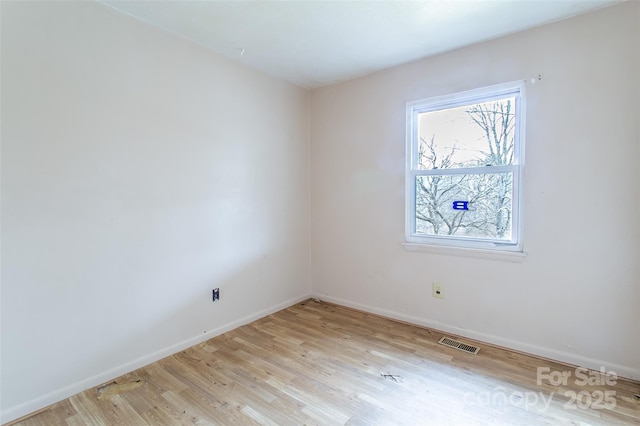 unfurnished room with light wood-type flooring