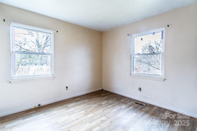 unfurnished room with light hardwood / wood-style floors