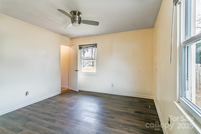 spare room with dark hardwood / wood-style flooring and ceiling fan