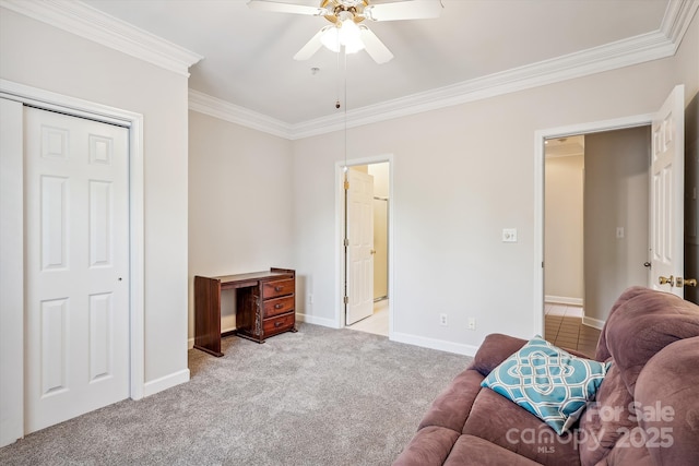 sitting room featuring ornamental molding, carpet, a ceiling fan, and baseboards