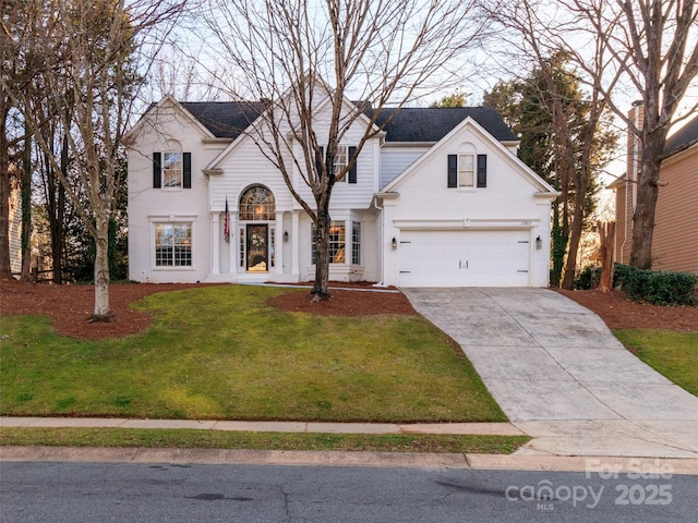 view of front of home featuring a garage, driveway, and a front lawn