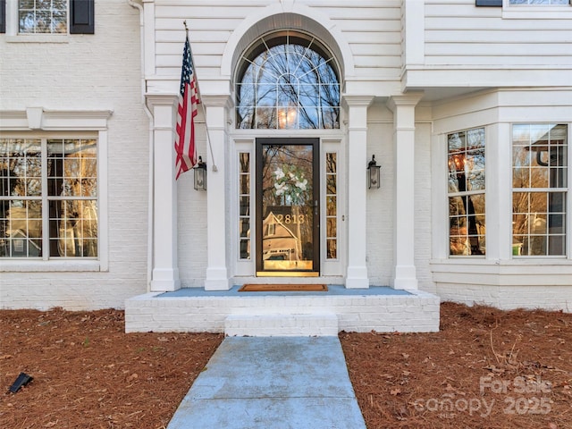 property entrance with brick siding