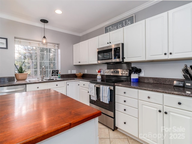 kitchen with crown molding, appliances with stainless steel finishes, a sink, and white cabinets