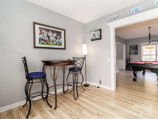 dining room featuring baseboards, billiards, and light wood-style floors