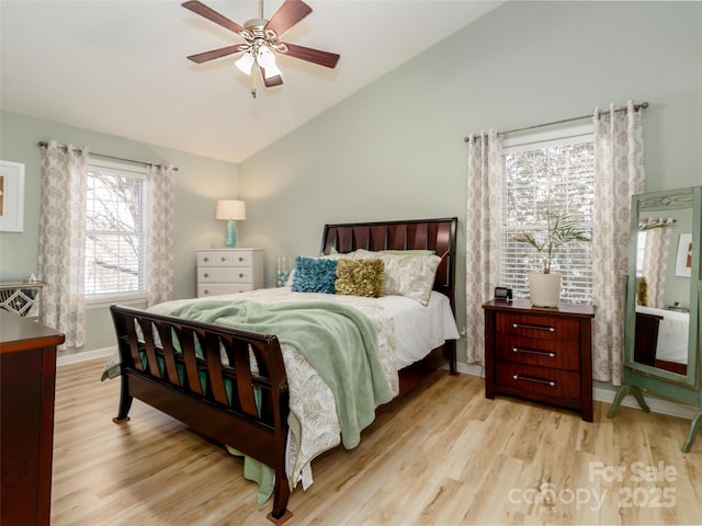 bedroom with a ceiling fan, lofted ceiling, baseboards, and light wood finished floors